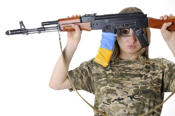 Close-up of a Ukrainian female soldier holding a rifle and looking through trigger guard isolated on a white background - 498555176