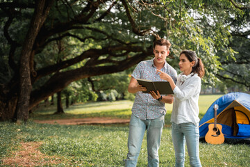 Fototapeta premium Young couple walking in the park with the romantic feeling. Love and tenderness, Romantic man smiling to his girlfriend, lifestyle concept