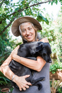 woman with dog smiling at home
