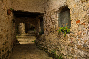 Fototapeta na wymiar An alley in Poffabro, an historic medieval village in the Val Colvera valley in Pordenone province, Friuli-Venezia Giulia, north east Italy 