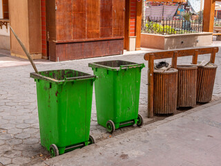 Garbage bins and garbage collection containers on city streets.