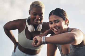 This is definitely our new record. Shot of two young women checking the time while out for a workout together. - obrazy, fototapety, plakaty