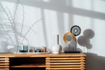 View of a modern minimalist Scandinavian style interior. Candles, ceramic vase and artistic home...