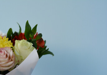 roses, asters bouquet on blue background. modern composition, space for text. Soft focus.