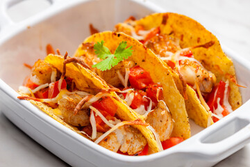 tacos filled with grilled chicken meat and tomatoes