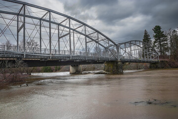 Historic Ouaquaga Bridge, on a cloudy spring morning, as it crosses the Susquehanna River in Upstate NY.  Broome county in Upstate NY.	
