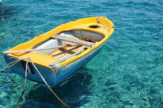 Close up shot on yellow blue boat floating on the Halki Island