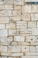old wall of old Romanesque blocks as a background, Benevento, Campania, Italy