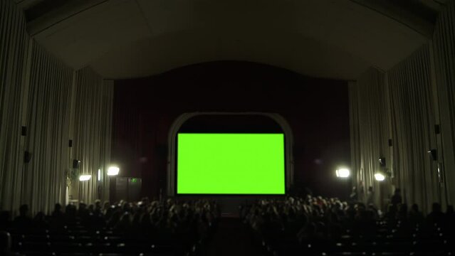 Cinema Hall with Green Screen and Blurred Audience. You can replace green screen with the footage or picture you want. You can do it with &ldquo;Keying&rdquo; effect in After Effects. 4K Resolution.