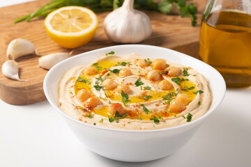 Delicious hummus with chickpeas, olive oil, lemon and pita bread. Vegetarian food concept.
