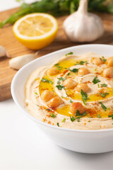 Delicious hummus with chickpeas, olive oil, lemon and pita bread. Vegetarian food concept.
