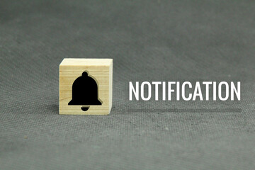 wooden cubes with bell icons and notification words