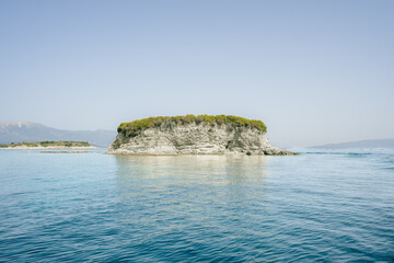 Scenery from a boat of Meganisi, Greece along with mini rock islands and water landscapes