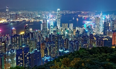 Fototapeta na wymiar Night scenery of Hong Kong viewed from Victoria Peak with city skyline of crowded skyscrapers by Victoria Harbour and Kowloon area across seaport ~ Beautiful cityscape of Hong Kong in blue twilight