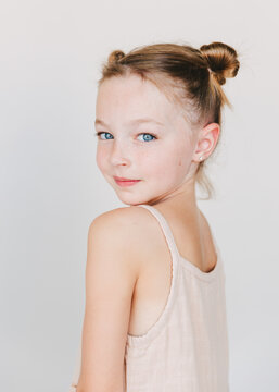 cute little girl looking over her shoulder, white background