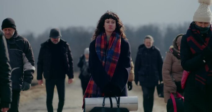 Sad Woman Amidst Refugees During War Crisis.