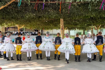 Rakvice, Czech Republic - June 2021. Beautiful women and men dancers in a celebration.Traditional Moravian feast. Young people in parade dressed in traditional Moravian folk costume. © Richard Semik