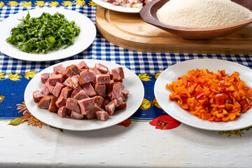 ingredients for preparing a recipe, bacon, cabbage, red bell pepper, manioc flour, egg, sausage, parsley, on a table