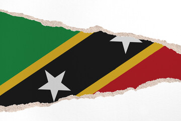 Ripped paper background in colors of national flag. Saint Kitts and Nevis