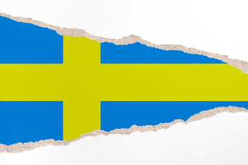 Ripped paper background in colors of national flag. Sweden
