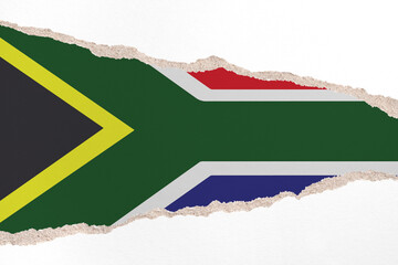 Ripped paper background in colors of national flag. South Africa