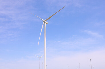 Wind turbines against the backdrop of a sunny sky. Green ecological energy generation. Eco field wind farm