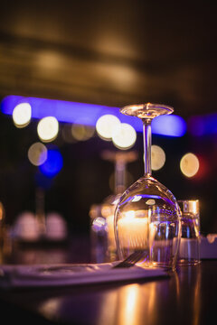 Vertical Shot Of An Upside Down Wine Glass On A Bokeh Background