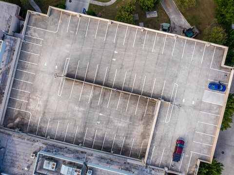 Aerial Top Shot Of A Parking Garage With Two Cars