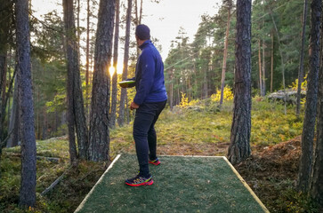 Person playing disc golf in a park