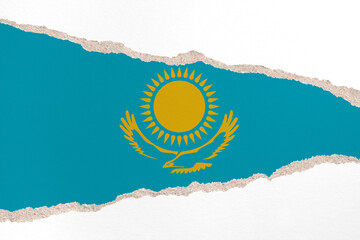 Ripped paper background in colors of national flag. Kazakhstan
