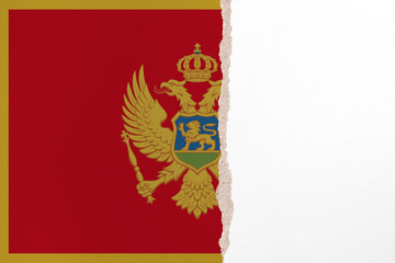 Half- ripped paper background in colors of national flag. Montenegro