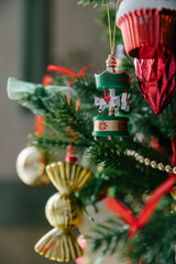 Beautiful decorations and toys on the Christmas tree, red and gold. Close-up, details of the Christmas tree