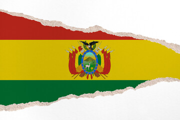 Ripped paper background in colors of national flag. Bolivia