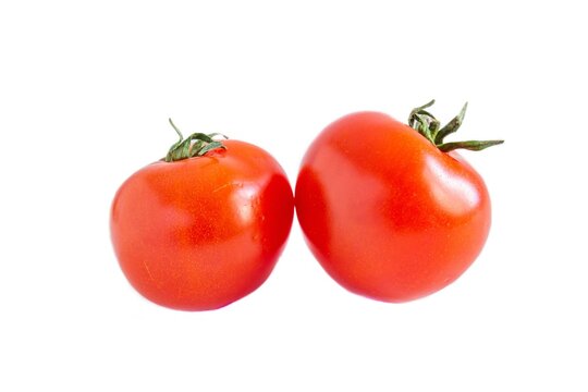 Closeup photo of ripe tomatoes isolated on white background