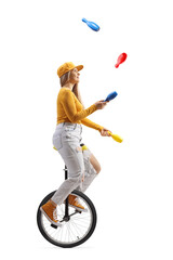 Young female riding a unicycle and juggling © Ljupco Smokovski