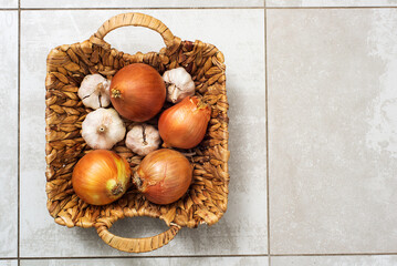 onions and garlic in a wicker basket