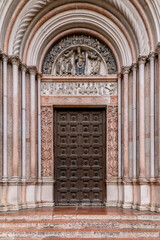 The entrance portal of the ancient baptistery, historic center of Parma, Italy