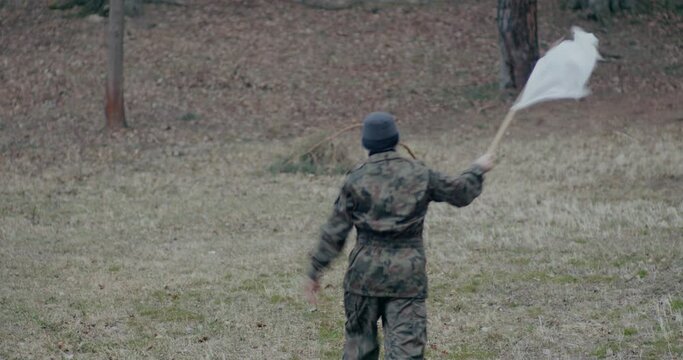 Military Man Waving White Flag During War.