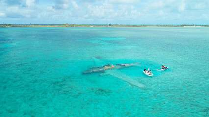 Aerial view of people  in a white tiny boat at Exumas, Bahamas