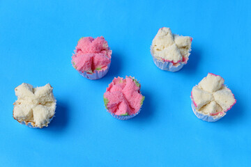 Steamed sponge cake, or bolu kukus food from Indonesia. isolated on a blue background