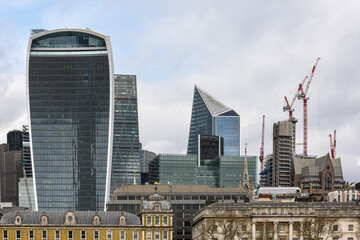 Fototapeta na wymiar New buildings rise up behind traditional architecture in London city skyline