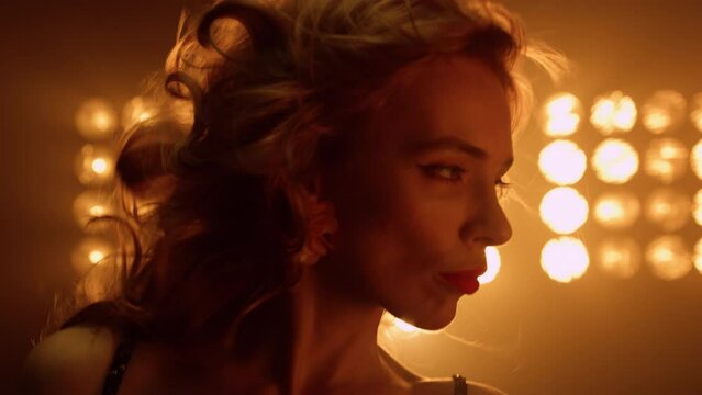 Hot model defile seducing on stage close up. Sensual blonde girl posing camera.