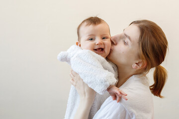a young mother kisses a child portrait. free space for text
