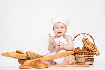 Little boy in a cook cap and with bread funny little chef