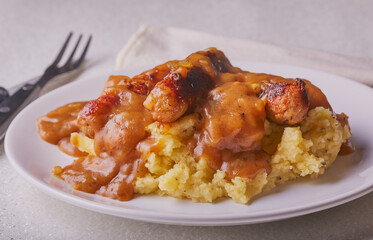 Sausage and mashed potatoes with onion gravy.