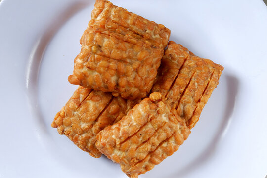 Closeup shot of a Indonesian traditional fried tempe garit on a white plate