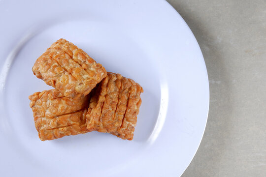 Closeup shot of a Indonesian traditional fried tempe garit on a white plate