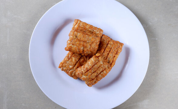 Closeup shot of a Indonesian traditional fried tempe garit on a white plate