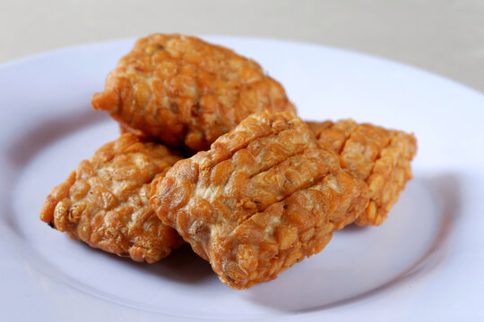 Closeup shot of a Indonesian traditional fried tempe garit on a white plate