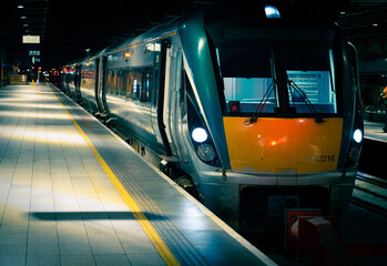 Beautiful shot of a modern train inside a Sligo Railway station in Ireland at night with lights